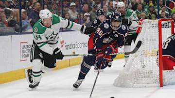 Feb 25, 2025; Columbus, Ohio, USA; Columbus Blue Jackets right wing Kirill Marchenko (86) and Dallas Stars center Mikael Granlund (64) chase down a loose puck during the first period at Nationwide Arena. Mandatory Credit: Russell LaBounty-Imagn Images