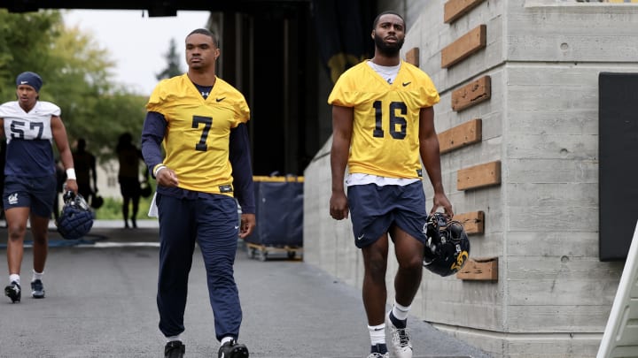 CJ Harris (16) enters Memorial Stadium with teammate Chandler Rogers