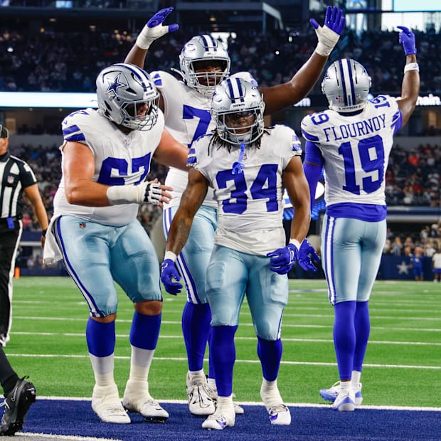 Teammates celebrate with Dallas Cowboys running back Jaydon Blue after he scores a touchdown against the Atlanta Falcons