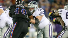 Kansas State senior offensive guard Cooper Beebe keeps Kansas redshirt senior defensive tackle Phillips out of the backfield