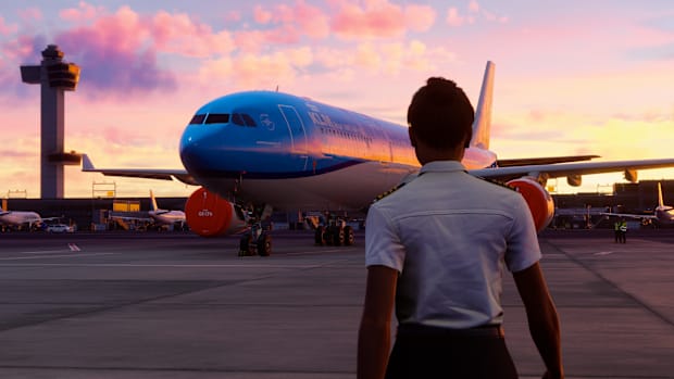 A pilot walking towards a KLM-branded jet airliner.