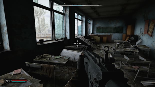 Stalker 2 screenshot of a bombed out classroom while you hold an automatic weapon.