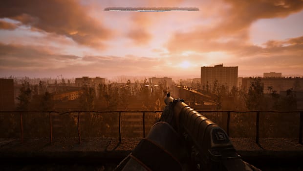 Stalker 2 screenshot of looking out at the setting sun while holding a gun.
