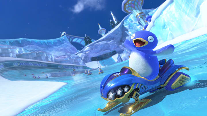 A penguin riding a snowmobile through an icy racetrack in Mario Kart World.