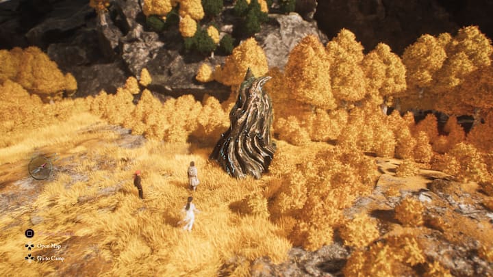 A glowing root made out of paint, sticking up from the ground of a yellow forrest.