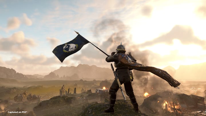 Helldivers 2 screenshot showing a soldier wave a flag.