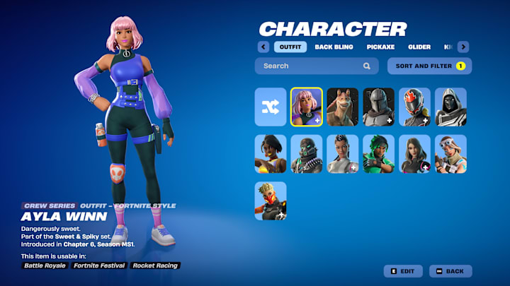 Ayla Winn, a woman with short pink hair wearing a black bodysuit with a purple top over it.