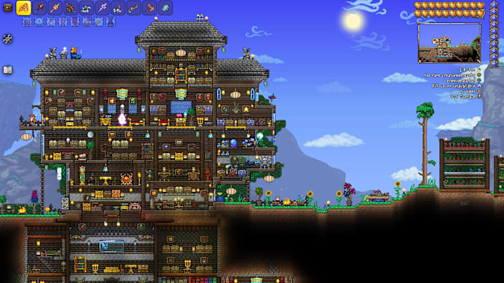 A 2D side-on look at a giant wooden mansion made in Terraria