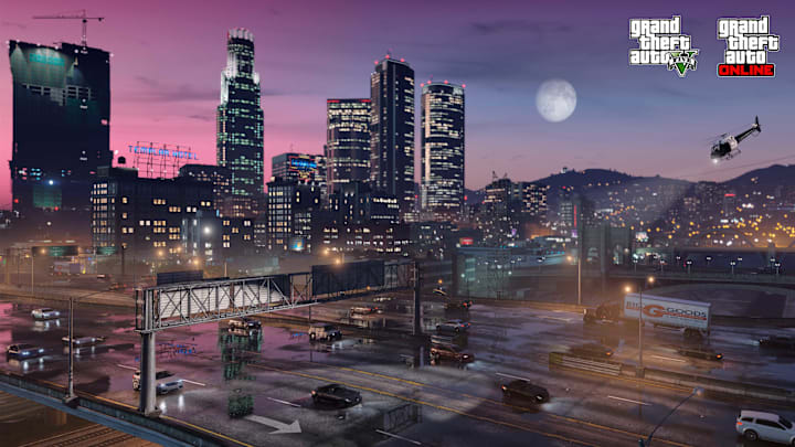 A shot of Los Santos just after sunset with the moon rising above the mountains and the skyscrapers in the background lit up.
