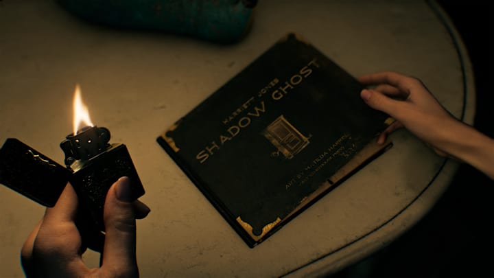 Grace holding up a lighter to illuminate a book titled "Shadow Ghost"