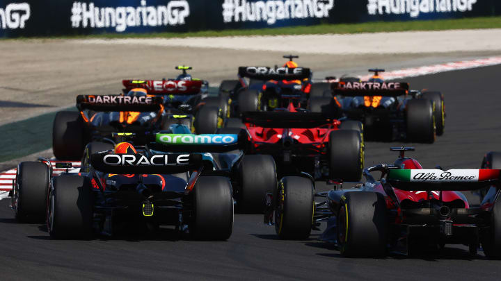 Sergio Perez of Mexico driving the (11) Oracle Red Bull Racing RB19 and Valtteri Bottas of Finland driving the (77) Alfa Romeo F1 C43 Ferrari battle for track position during the F1 Grand Prix of Hungary at Hungaroring on July 23, 2023 in Budapest, Hungary. (Photo by Mark Thompson/Getty Images)