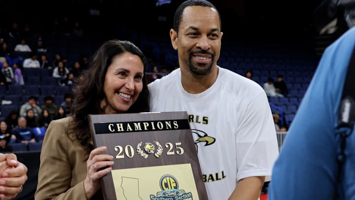 Oak Park girls basketball coach Will Burr (right) accepts the CIF Southern Section Division 2AA title, making his fourth straight championship as a head coach at a combined two schools. Oak Park girls basketball coach Will Burr (right) accepts the CIF Southern Section Division 2AA title, making his fourth straight championship as a head coach at a combined two schools.
