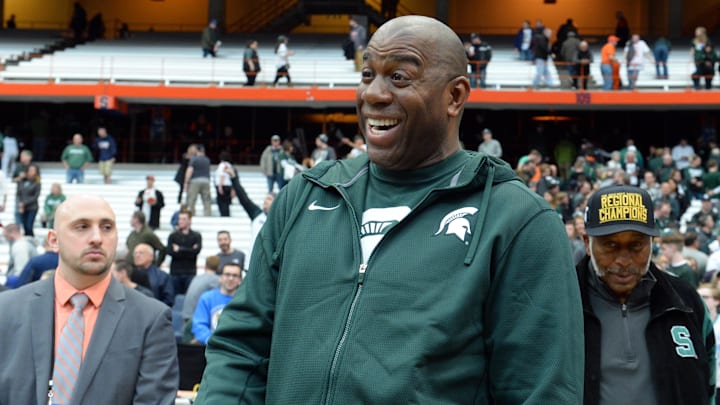 Mar 29, 2015; Syracuse, NY, USA; Michigan State Spartans former player Magic Johnson celebrates after the game against the Louisville Cardinals in the finals of the east regional of the 2015 NCAA Tournament at Carrier Dome. The Michigan State Spartans won 76-70.Mandatory Credit: Rich Barnes-Imagn Images