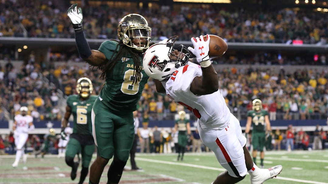 Nov 16, 2013; Arlington, TX, USA; Texas Tech Red Raiders receiver Eric Ward (18) catches a touchdown pass in the first quarter against Baylor Bears cornerback K.J. Morton (8) at AT&T Stadium. Mandatory Credit: Matthew Emmons-Imagn Images