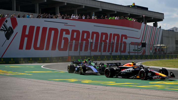  Sergio Perez of Mexico driving the (11) Oracle Red Bull Racing RB20 leads Logan Sargeant of United States driving the (2) Williams FW46 Mercedes during the F1 Grand Prix of Hungary at Hungaroring on July 21, 2024 in Budapest, Hungary. 