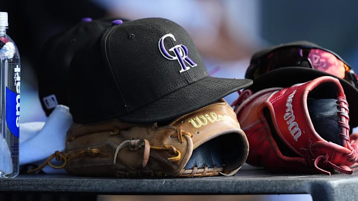 General view of a players cap and glove of the Colorado Rockies during the ninth inning against the Chicago White Sox at Coors Field. General view of a players cap and glove of the Colorado Rockies during the ninth inning against the Chicago White Sox at Coors Field.