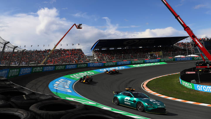 ZANDVOORT, NETHERLANDS - AUGUST 27: The FIA Safety Car leads Max Verstappen of the Netherlands driving the (1) Oracle Red Bull Racing RB19 and Sergio Perez of Mexico driving the (11) Oracle Red Bull Racing RB18 during the F1 Grand Prix of The Netherlands at Circuit Zandvoort on August 27, 2023 in Zandvoort, Netherlands. (Photo by Peter Fox/Getty Images)