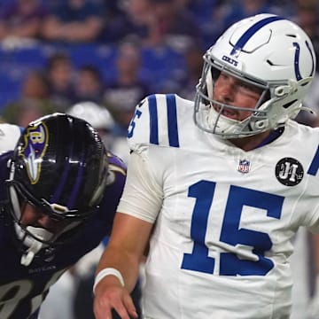 Aug 7, 2025; Baltimore, Maryland, USA; Indianapolis Colts quarterback Riley Leonard (15) under pressure by Baltimore Ravens lineman C.J. Ravenell (91) during the fourth quarter at M&T Bank Stadium. Mandatory Credit: Mitch Stringer-Imagn Images