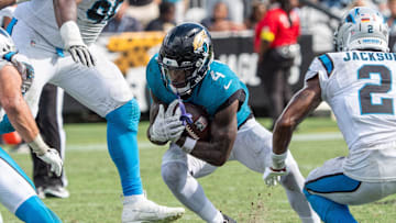 Jacksonville Jaguars running back Tank Bigsby (4) eludes Carolina Panthers defensive end Derrick Brown (95) an d Carolina Panthers cornerback Mike Jackson (2) during the fourth quarter of an NFL football game between the Carolina Panthers at Jacksonville Jaguars at EverBank Stadium Sunday September 7, 2025. Jaguars defeated the Panthers 26-10. 