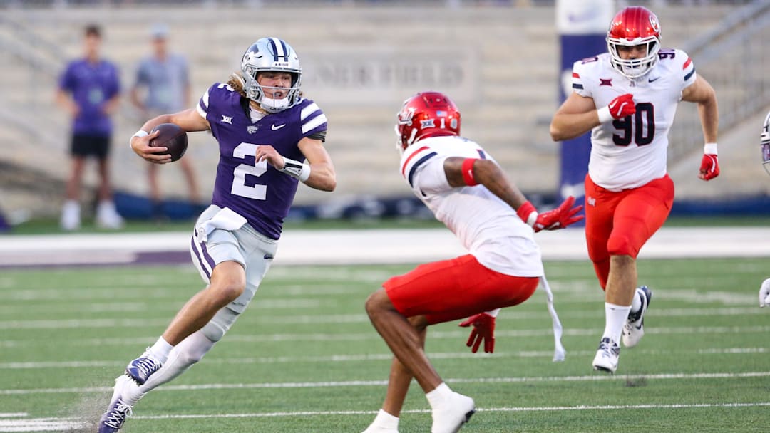 Sep 13, 2024; Manhattan, Kansas, USA; Kansas State Wildcats quarterback Avery Johnson (2) looks for room to run against Arizona Wildcats defensive back Tacario Davis (1) during the first quarter at Bill Snyder Family Football Stadium.