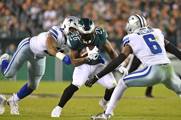 Philadelphia Eagles running back Miles Sanders makes a move against Dallas Cowboys safety Donovan Wilson 