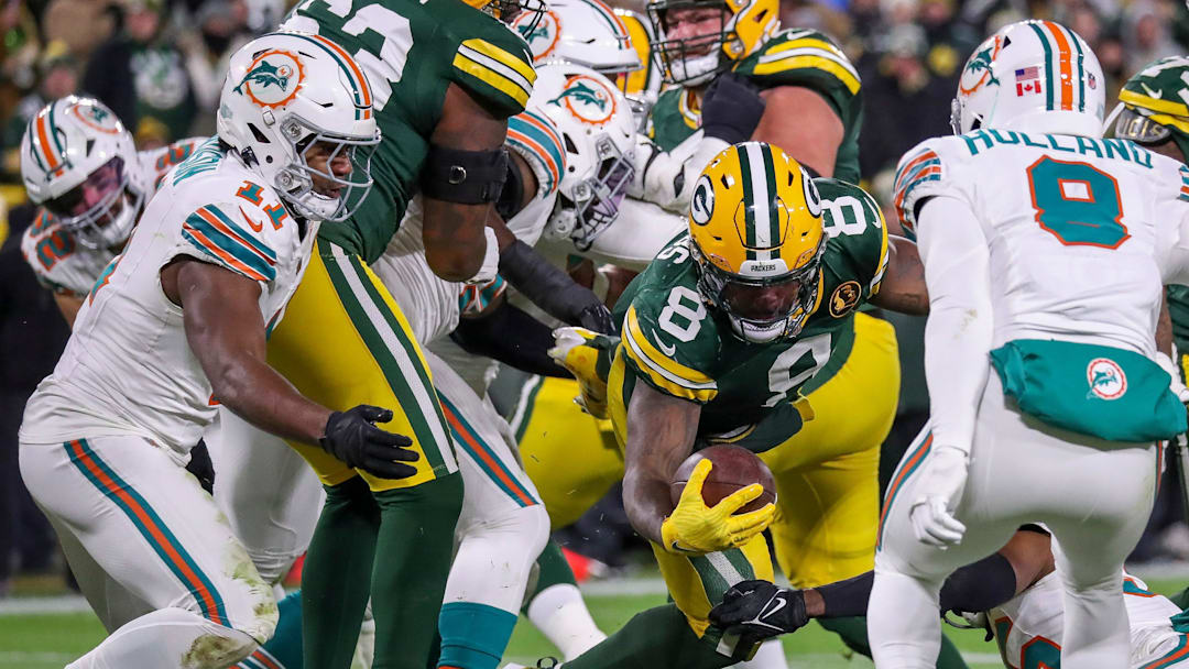Green Bay Packers running back Josh Jacobs (8) reaches the ball across the goal line for a touchdown against the Miami Dolphins on Thursday, Nov. 28, 2024, at Lambeau Field in Green Bay, Wis. The Packers won the game, 30-17.