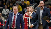Wisconsin Badgers head coach Greg Gard (left) walks onto the court during a time out in the first half of the 2025 TIAA Big Ten Men’s Basketball Tournament final game against the Michigan Wolverines on Sunday, March 16, 2025, at Gainbridge Fieldhouse in Indianapolis. 