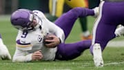 Minnesota Vikings quarterback J.J. McCarthy (9) trips on a teammate during the first quarter of their game against the Green Bay Packers Sunday, November 23, 2025 at Lambeau Field in Green Bay, Wisconsin.