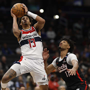 Feb 26, 2025; Washington, District of Columbia, USA; Washington Wizards guard Jordan Poole (13) shoots the ball as Portland Trail Blazers guard Shaedon Sharpe (17) defends in the second half at Capital One Arena. Mandatory Credit: Geoff Burke-Imagn Images