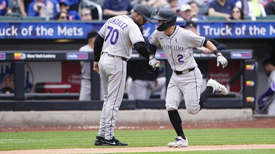 Jun 1, 2025; New York City, New York, USA; Colorado Rockies third base coach Andy Gonzalez (70) congratulates Colorado Rockies right fielder Tyler Freeman (2) for hitting a home run against the New York Mets during the fifth inning at Citi Field.