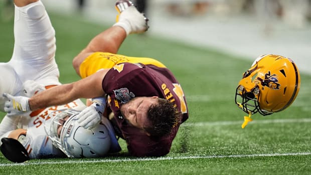 Arizona State Sun Devils running back Cam Skattebo (4) loses his helmet while being tackled by Texas DB Michael Taaffe