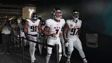 Sep 16, 2024; Philadelphia, Pennsylvania, USA; Atlanta Falcons defensive tackle David Onyemata (90), wide receiver Darnell Mooney (1) and defensive end Grady Jarrett (97) lead the team onto the field against the Philadelphia Eagles at Lincoln Financial Field. Mandatory Credit: Eric Hartline-Imagn Images