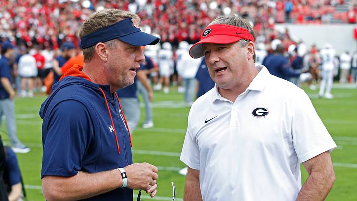 Auburn head coach Hugh Freeze speaks with Georgia head coach Kirby Smart before the start of a NCAA college football game in Athens, Ga., on Saturday, Oct. 5, 2024.