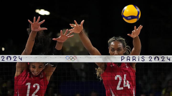 Aug 8, 2024; Paris, France; United States opposite Jordan Thompson (12) and middle blocker Chiaka Ogbogu (24) go for a block against Brazil in a women's volleyball semifinal match during the Paris 2024 Olympic Summer Games at South Paris Arena 1. Mandatory Credit: Michael Madrid-USA TODAY Sports