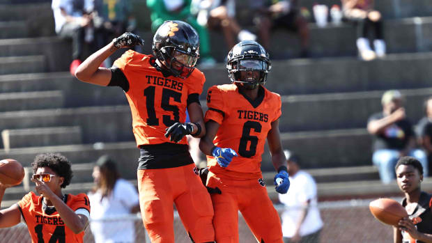 Withrow's Chris Henry Jr (15) and Kristian Bonner (6) celebrate during the Tigers' 31-0 win over Taft Saturday,