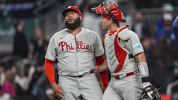 Apr 9, 2025; Cumberland, Georgia, USA; Philadelphia Phillies pitcher José Alvarado (46) reacts with catcher J.T. Realmuto (10) after the Phillies defeated the Atlanta Braves at Truist Park.