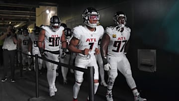 Sep 16, 2024; Philadelphia, Pennsylvania, USA; Atlanta Falcons defensive tackle David Onyemata (90), wide receiver Darnell Mooney (1) and defensive end Grady Jarrett (97) lead the team onto the field against the Philadelphia Eagles at Lincoln Financial Field. Mandatory Credit: Eric Hartline-Imagn Images