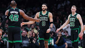 Boston, Massachusetts, USA; Boston Celtics forward Jayson Tatum (0) and center Al Horford (42) react after a play against the Indiana Pacers in the second half at TD Garden.