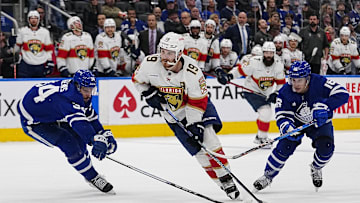May 4, 2023; Toronto, Ontario, CANADA; Florida Panthers forward Matthew Tkachuk (19) carries the puck past Toronto Maple Leafs defenseman Morgan Rielly (44) and forward Mitchell Marner (16) during the second period of game two of the second round of the 2023 Stanley Cup Playoffs at Scotiabank Arena. Mandatory Credit: John E. Sokolowski-Imagn Images