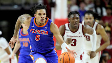 Jan 11, 2025; Fayetteville, Arkansas, USA; Florida Gators guard Will Richard (5) leads a fast break against Arkansas Razorbacks forward Adou Thiero (3) in the second half at Bud Walton Arena. Florida won 71-63. Mandatory Credit: Nelson Chenault-Imagn Images