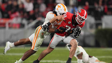 Georgia running back Cash Jones (32) is tackled by Tennessee linebacker Arion Carter (7) during a college football game between Tennessee and Georgia at Sanford Stadium in Athens, Ga., on Saturday, November 16, 2024.
