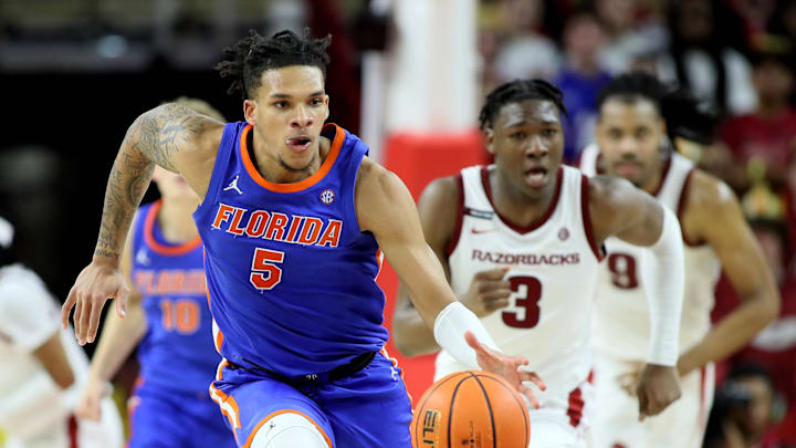 Jan 11, 2025; Fayetteville, Arkansas, USA; Florida Gators guard Will Richard (5) leads a fast break against Arkansas Razorbacks forward Adou Thiero (3) in the second half at Bud Walton Arena. Florida won 71-63. Mandatory Credit: Nelson Chenault-Imagn Images
