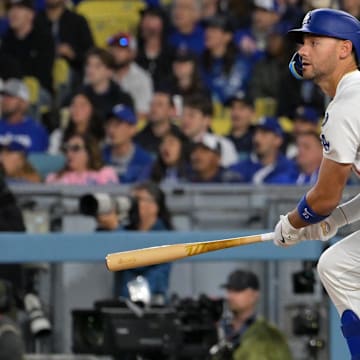 Mar 31, 2025; Los Angeles, California, USA; Los Angeles Dodgers outfielder Michael Conforto (23) hits a RBI double during the third inning against the Atlanta Braves at Dodger Stadium. Mandatory Credit: Jayne Kamin-Oncea-Imagn Images