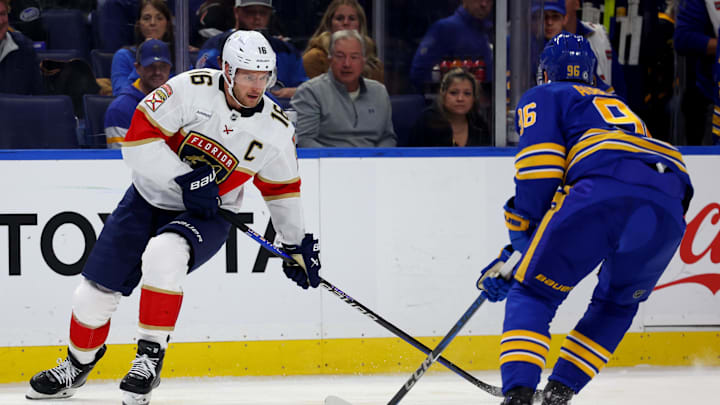Oct 28, 2024; Buffalo, New York, USA;  Florida Panthers center Aleksander Barkov (16) looks to make a pass as Buffalo Sabres right wing Nicolas Aube-Kubel (96) defends during the first period at KeyBank Center. Mandatory Credit: Timothy T. Ludwig-Imagn Images