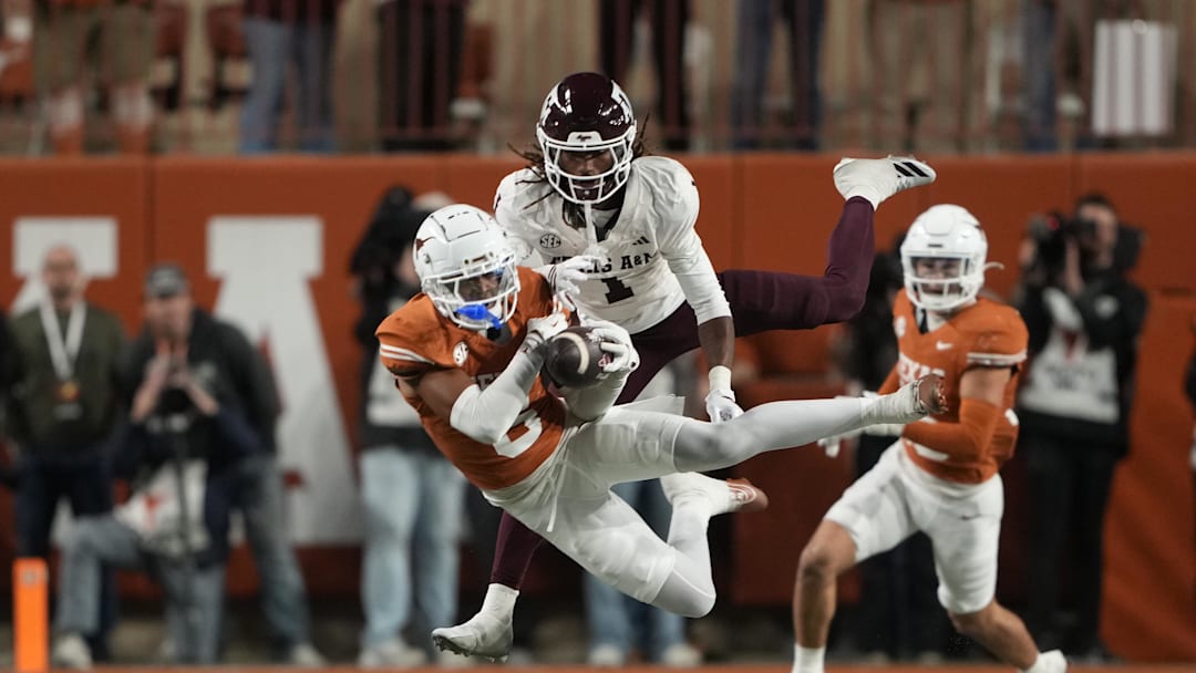 Nov 28, 2025; Austin, Texas, USA; Texas Longhorns defensive back Kobe Black (6) makes an interception on a pass intended for Texas A&M Aggies wide receiver Mario Craver (1) during the second half at Darrell K Royal-Texas Memorial Stadium. Mandatory Credit: Scott Wachter-Imagn Images Nov 28, 2025; Austin, Texas, USA; Texas Longhorns defensive back Kobe Black (6) makes an interception on a pass intended for Texas A&M Aggies wide receiver Mario Craver (1) during the second half at Darrell K Royal-Texas Memorial Stadium. Mandatory Credit: Scott Wachter-Imagn Images