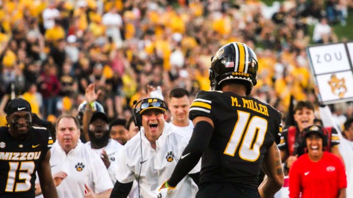 The Missouri football sideline celebrates with Mekhi Miller (10) after Miller scored his first career touchdown against South Dakota at Memorial Stadium on August 31, 2023, in Columbia, Mo.