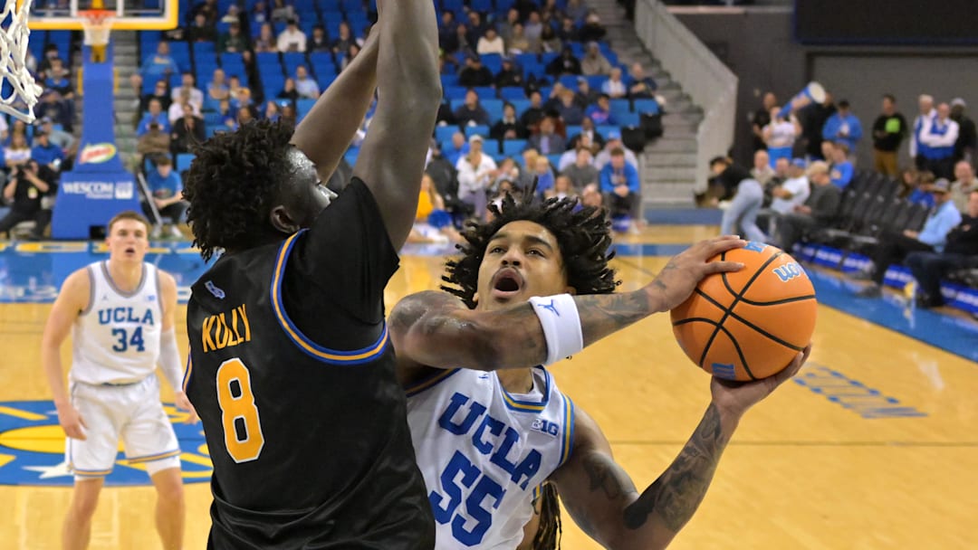 Dec 23, 2025; Los Angeles, California, USA; UCLA Bruins guard Skyy Clark (55) is defended by UC Riverside Highlanders forward BJ Kolly (8) as he drives to the basket in the first half at Pauley Pavilion presented by Wescom Financial. Mandatory Credit: Jayne Kamin-Oncea-Imagn Images