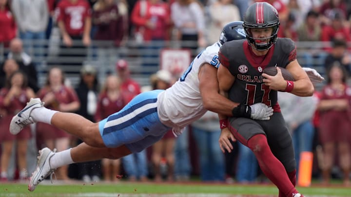 Oklahoma Sooners quarterback Jackson Arnold (11) is brought down by Maine Black Bears defensive lineman Jacob Tuiasosopo (56) during a college football game between the University of Oklahoma Sooners (OU) and the Maine Black Bears at Gaylord Family - Oklahoma Memorial Stadium in Norman, Okla., Saturday, Nov. 2, 2024.