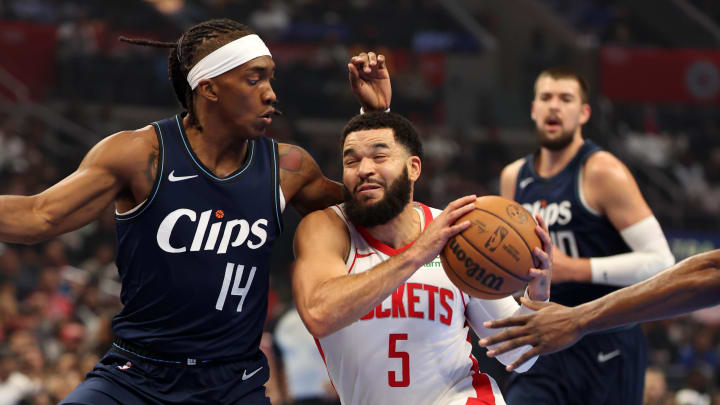 Nov 17, 2023; Los Angeles, California, USA;  Houston Rockets guard Fred VanVleet (5) drives to the basket against L.A. Clippers guard Terance Mann (14) during the first quarter at Crypto.com Arena. Mandatory Credit: Kiyoshi Mio-USA TODAY Sports