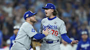 Nov 1, 2025; Toronto, Ontario, CAN; Los Angeles Dodgers third baseman Max Muncy (13) and pitcher Justin Wrobleski (70) react after Toronto Blue Jays shortstop Andres Gimenez (0) is hit by a pitch in the fourth inning during game seven of the 2025 MLB World Series at Rogers Centre. Mandatory Credit: John E. Sokolowski-Imagn Images